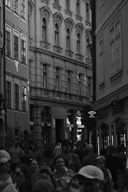 An atmospheric black-and-white shot of a lively street event capturing candid expressions