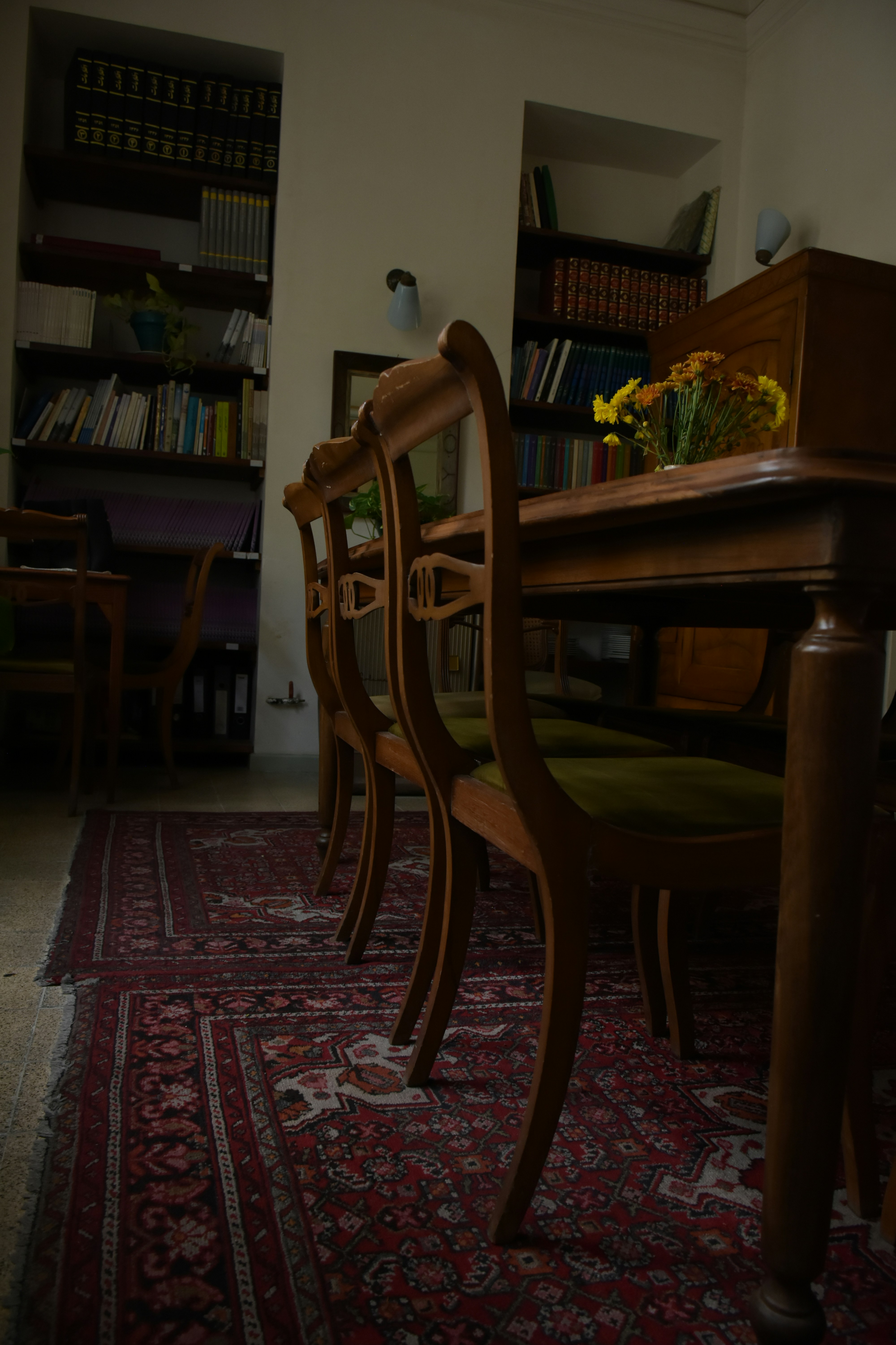 a room with a table and chairs and a rug