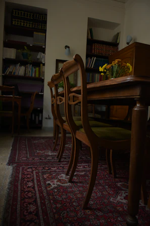 A calm, blue-toned meeting room with legal books and a laptop open.