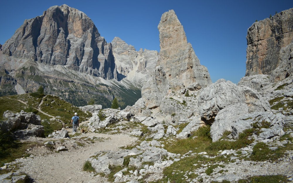 a couple of people that are walking on a trail