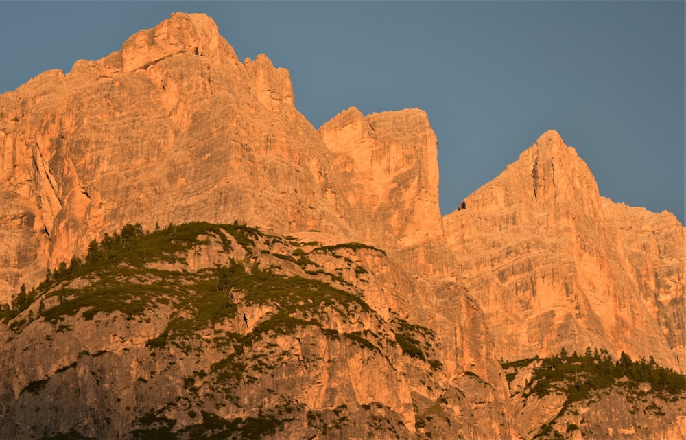 a very tall mountain with a sky in the background