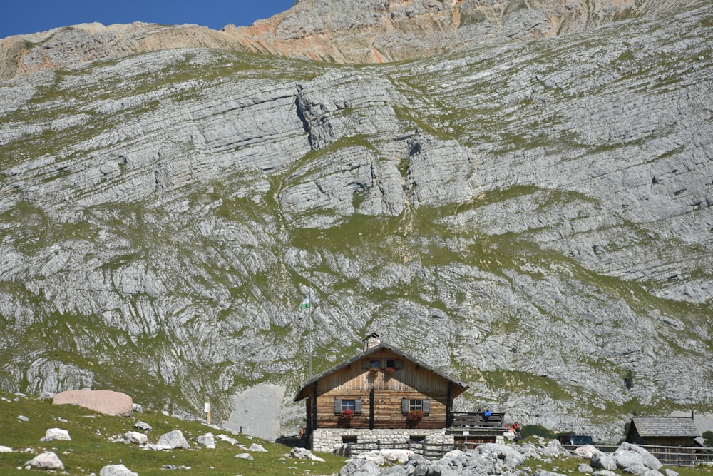 a small cabin in the middle of a mountain