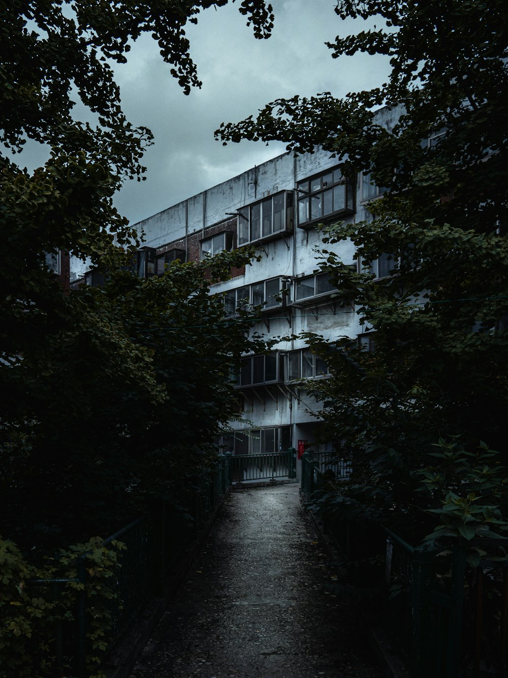 a dark street with a building in the background