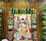 Colorful altar decorated with flowers, incense, and spiritual symbols