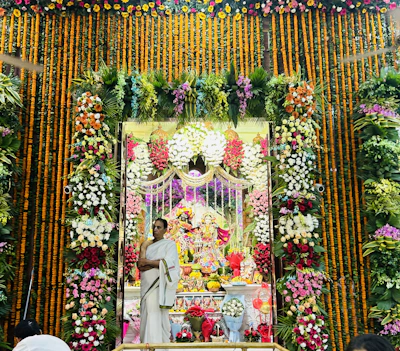 A colorful vase adorned with traditional Umbanda motifs placed on a wooden altar.