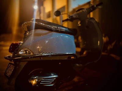 Evening shot of a ridenest scooter illuminated by streetlights on a quiet neighborhood street.