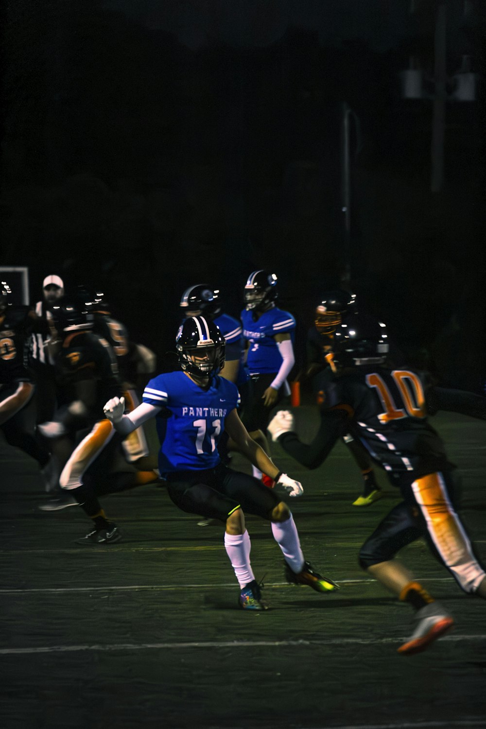 a football player running with the ball during a game