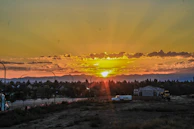 Sunset casting golden light over a modern township development in Dehradun.