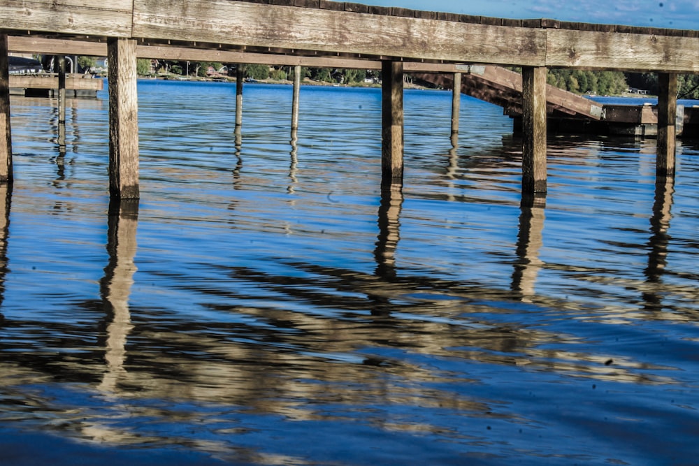 a wooden dock with a boat in the water