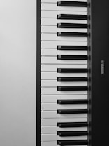 A close-up view of a Yamaha keyboard showcasing its black and white keys, with the brand name visible on the right side.
