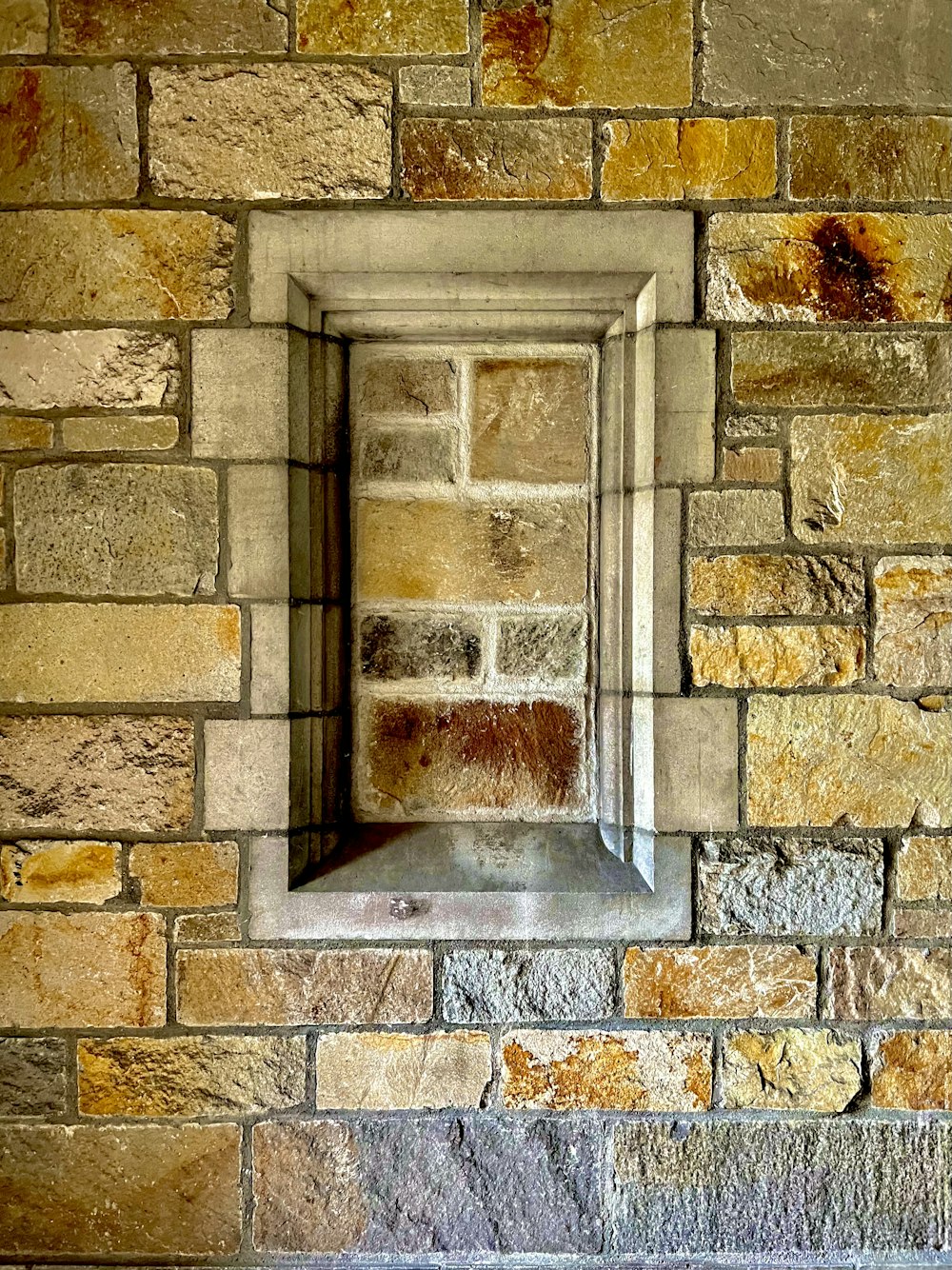 a brick wall with a window in it