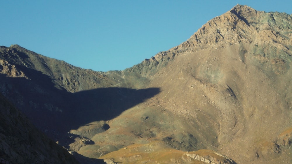 a view of a mountain range from the top of a hill