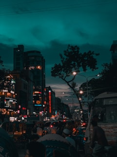 A vibrant street scene in Durgapur at dusk, with glowing city lights and bustling locals.