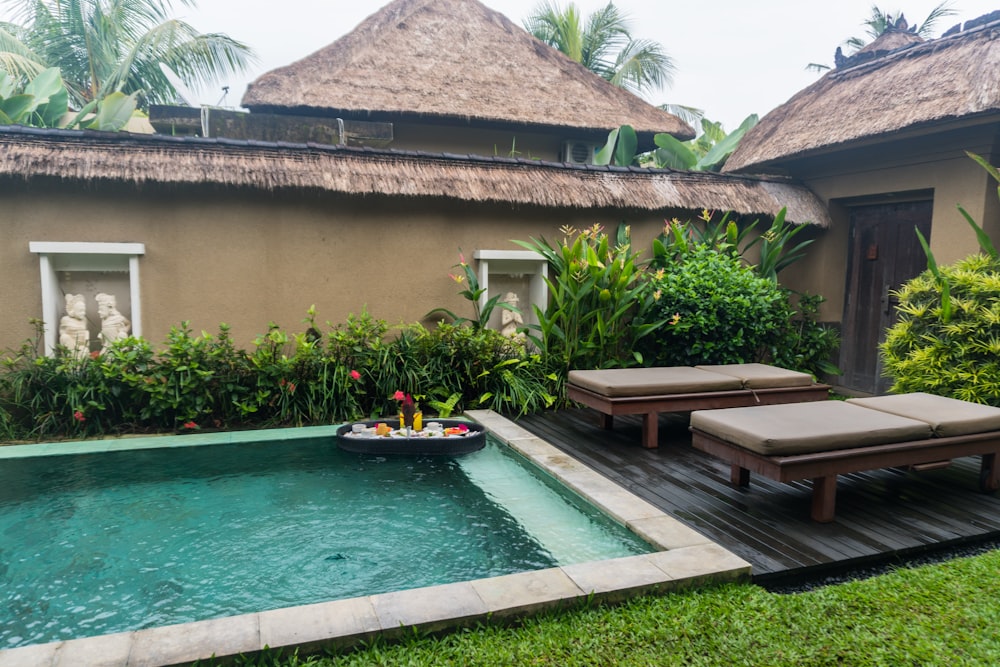 a small pool with lounge chairs next to it