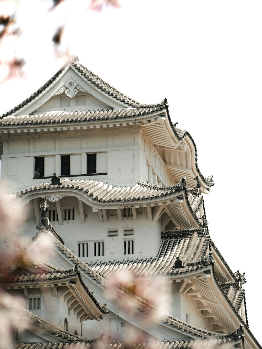 a tall white building with a clock on it's side