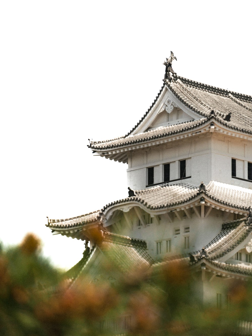 a tall white building with a clock on the top of it