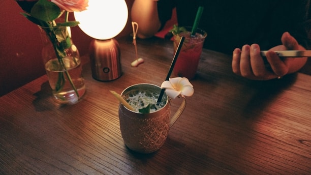 A serene morning scene with a soft lavender glow illuminating a journal, a cup of herbal tea, and a smartphone displaying the gluta.ai app interface.