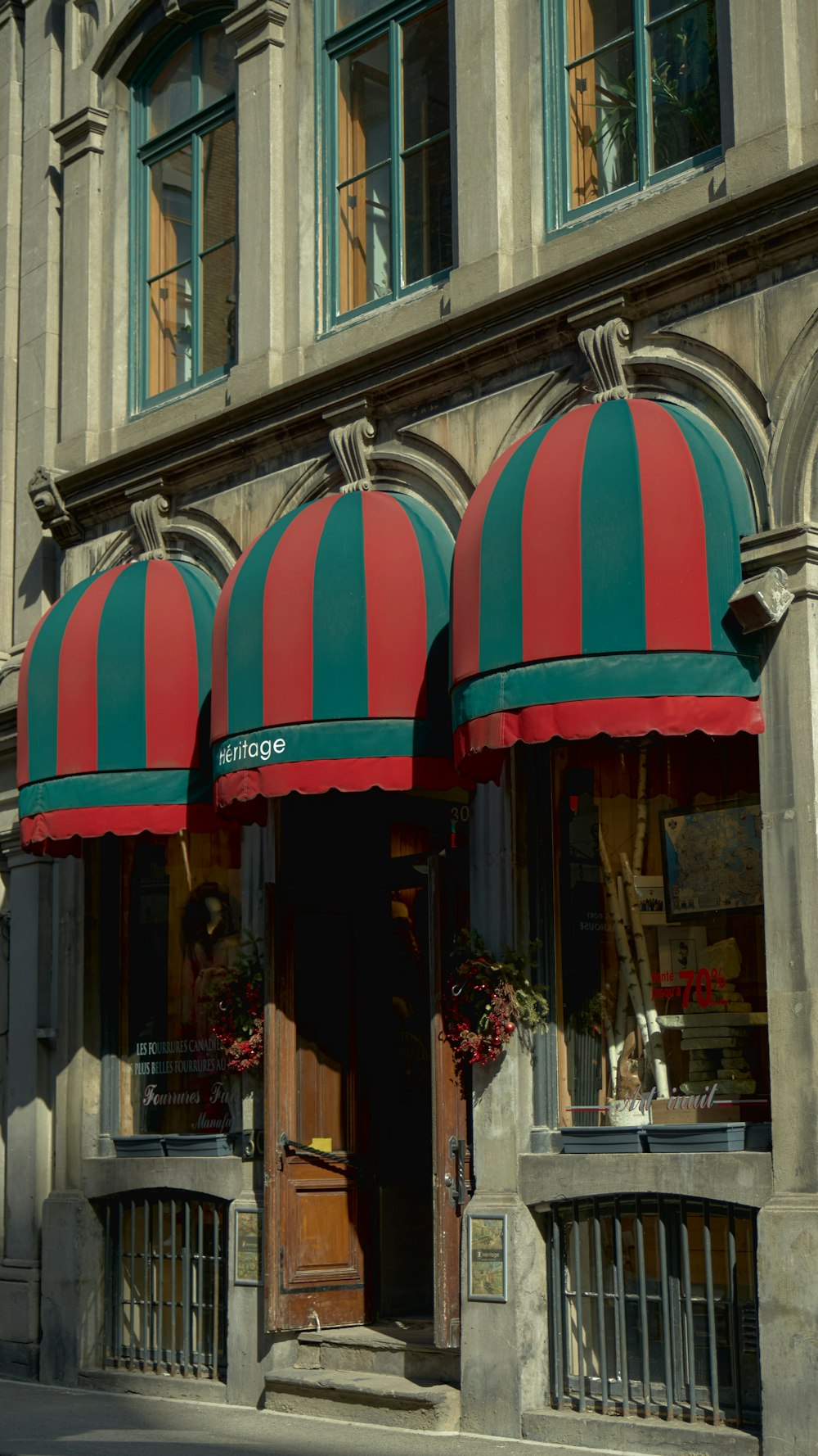 a store front with a red and green awning