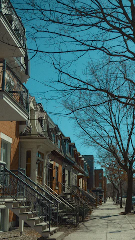 A quiet residential street in Chicago featuring well-maintained brick townhouses without people.