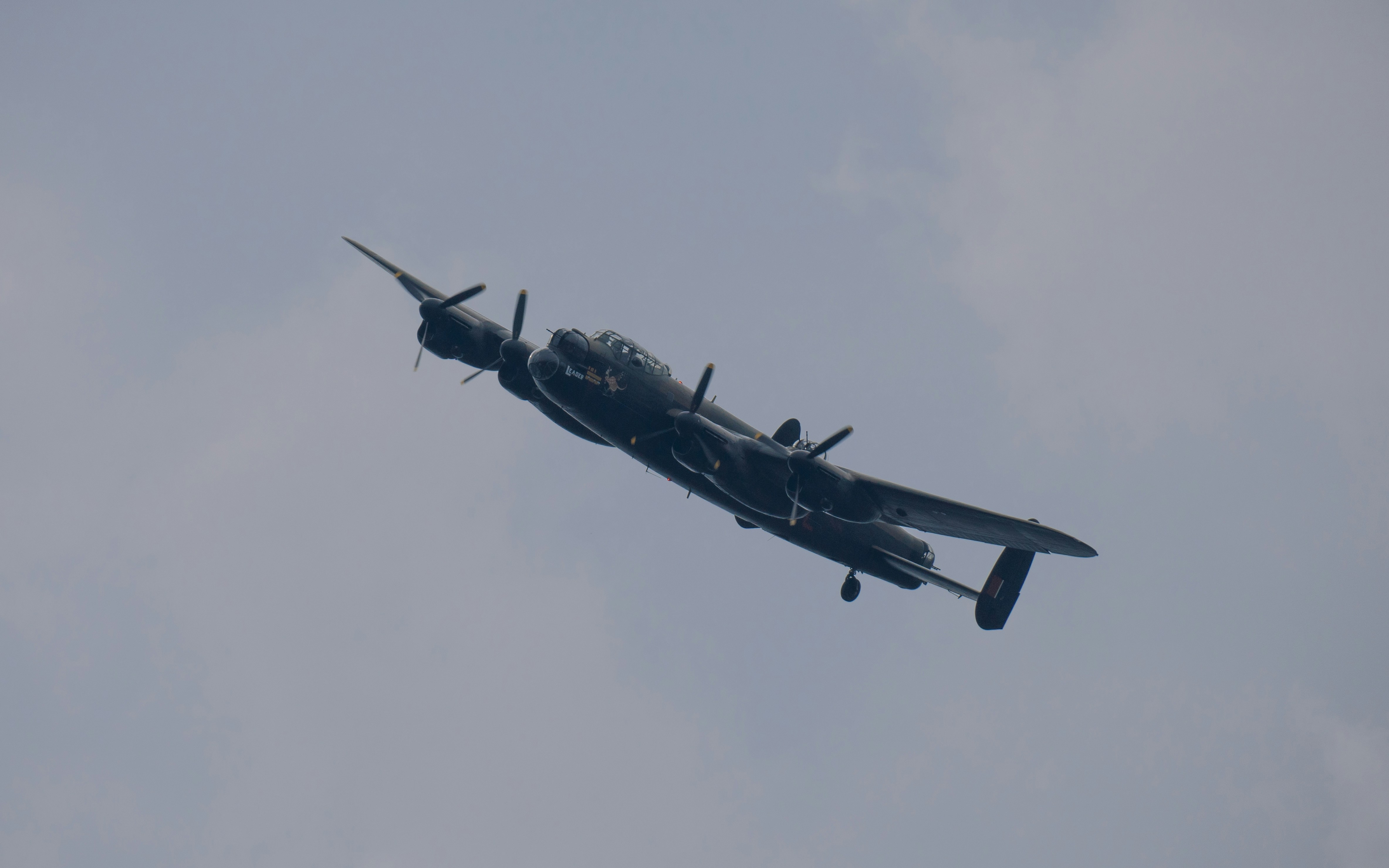 a plane flying in the sky on a cloudy day, Avro Lancaster PA474 on a Battle of Britain memorial flight over Nottingham - 17th of September 2023.