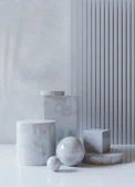Styled image of several pieces stacked artfully on a white marble surface, blending modern and timeless design.