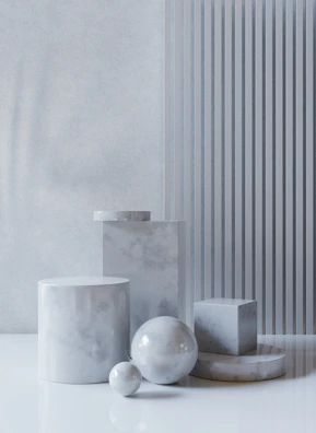 Styled image of several pieces stacked artfully on a white marble surface, blending modern and timeless design.