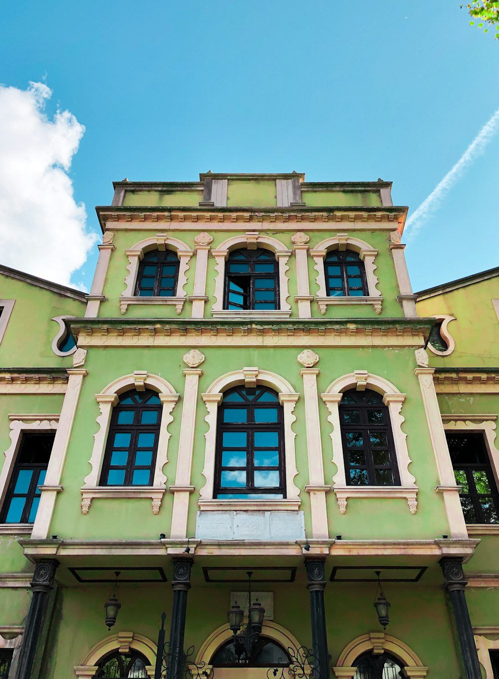 a large green building with many windows