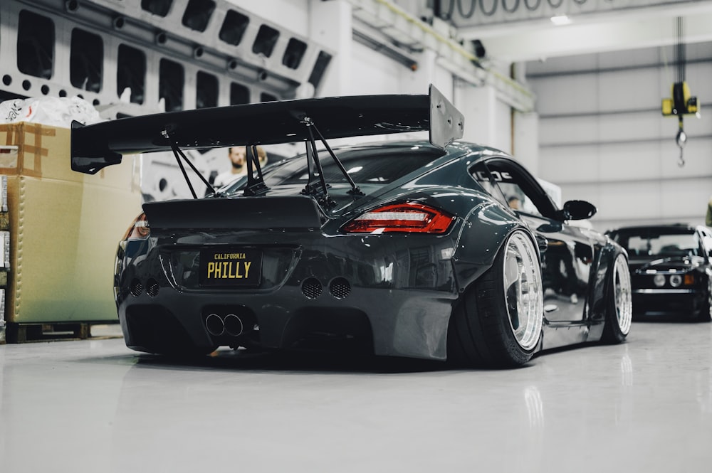 a black sports car parked in a garage