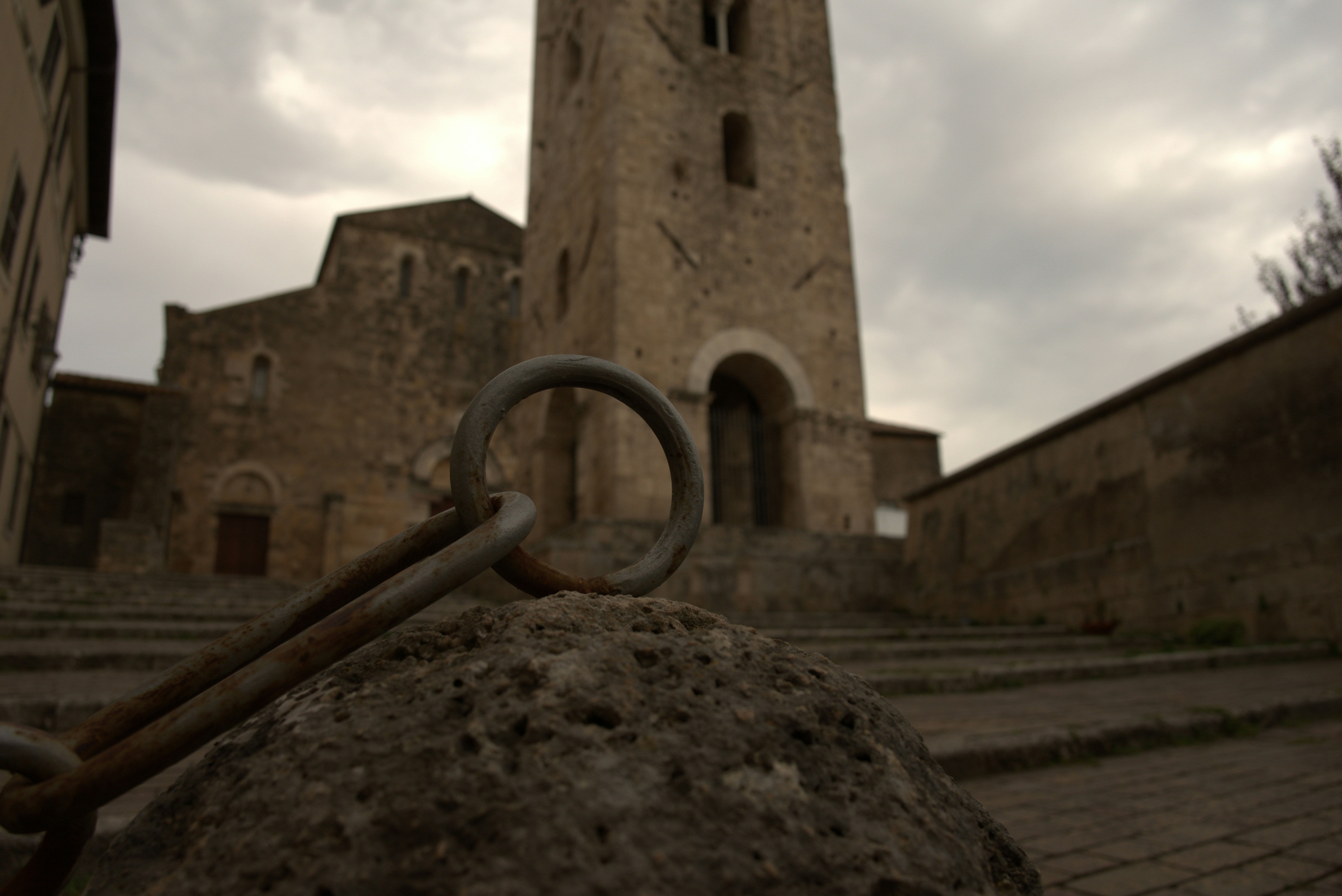 Cistercians, dunes and Tiberius’ grotto – by camper from Anagni via Fossanova and Ninfa to Monte Circeo and Sperlonga – a large stone building with a clock tower in the background