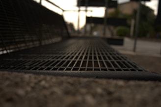 Close-up of durable metal urban furniture in a city park environment.