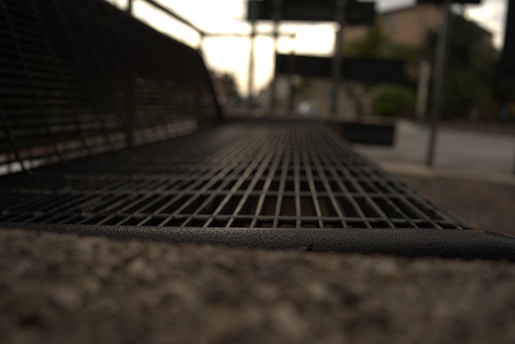 Close-up of durable metal urban furniture in a city park environment.