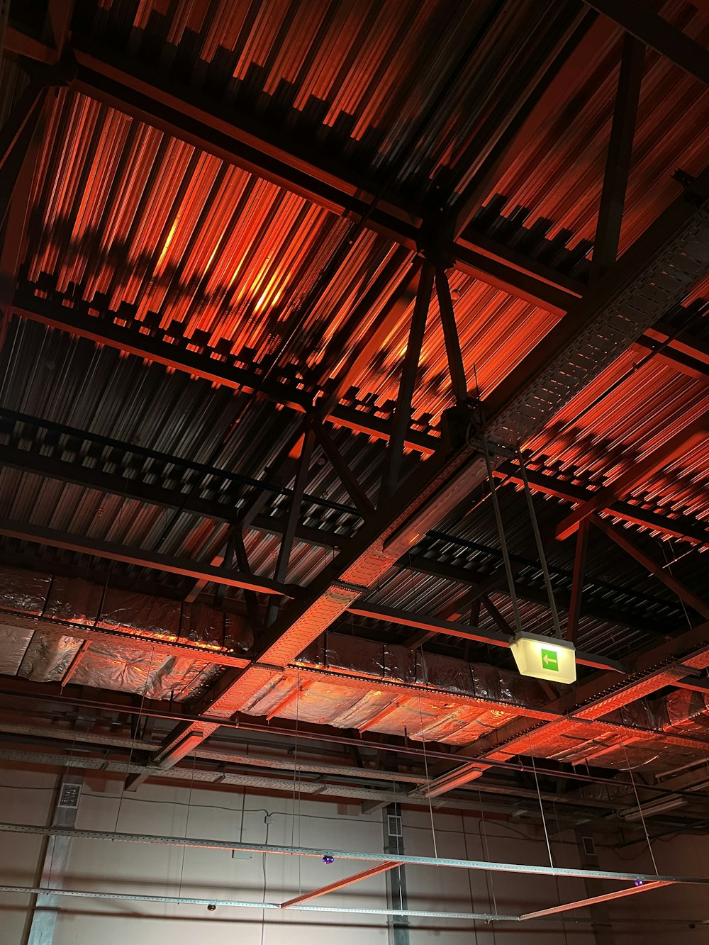 a room with a ceiling made of metal pipes