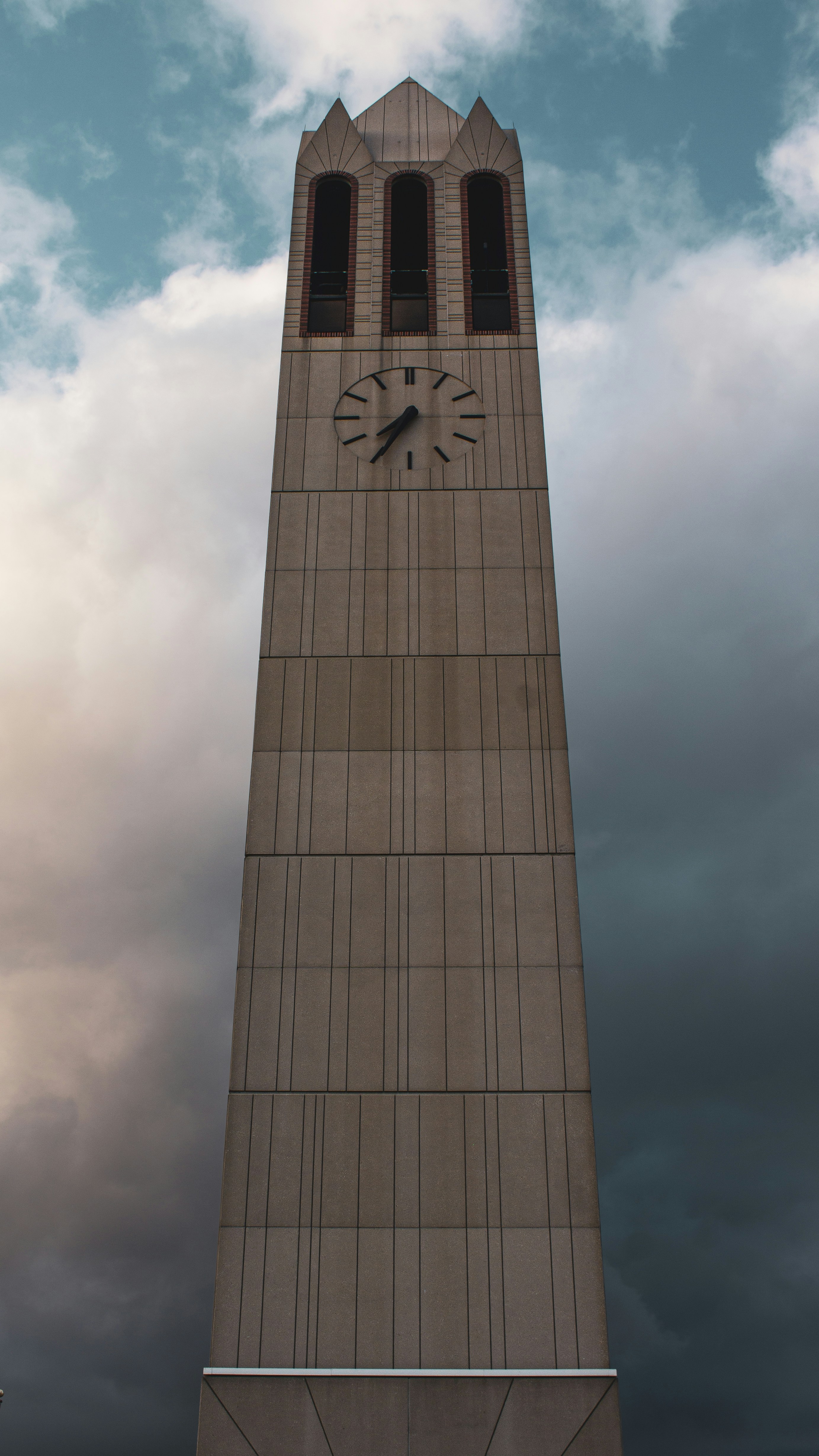 a tall clock tower sitting under a cloudy sky