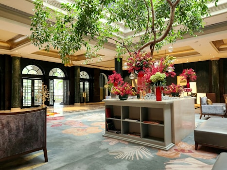A vibrant hotel lobby with welcoming staff and elegant decor.
