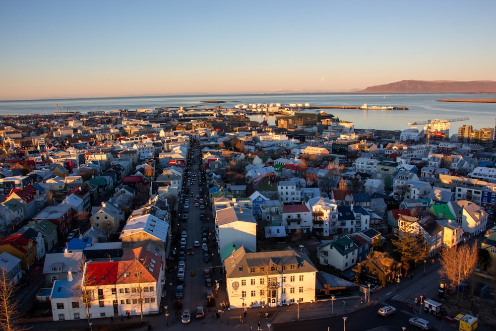 an aerial view of a city with a body of water in the background