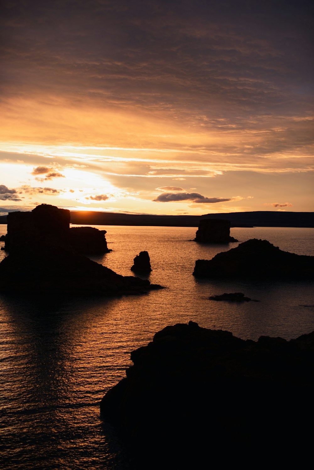 the sun is setting over a body of water