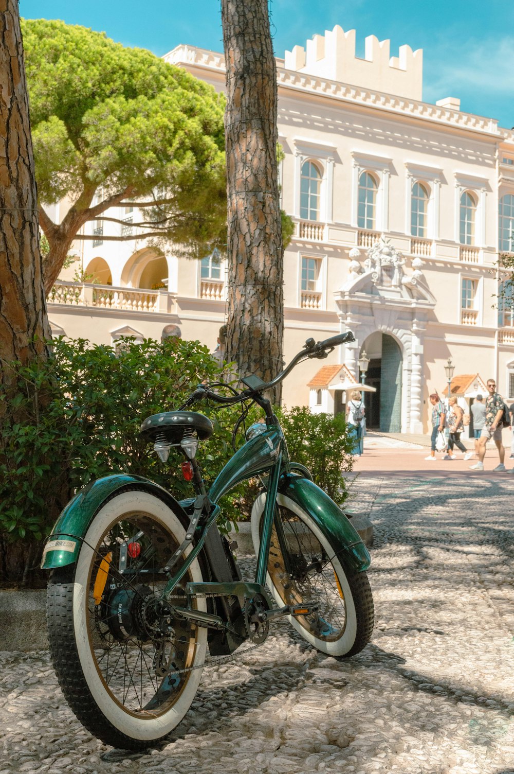 a green and white motorcycle parked in front of a building