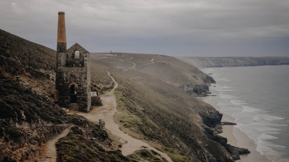 an old tower on a cliff overlooking the ocean