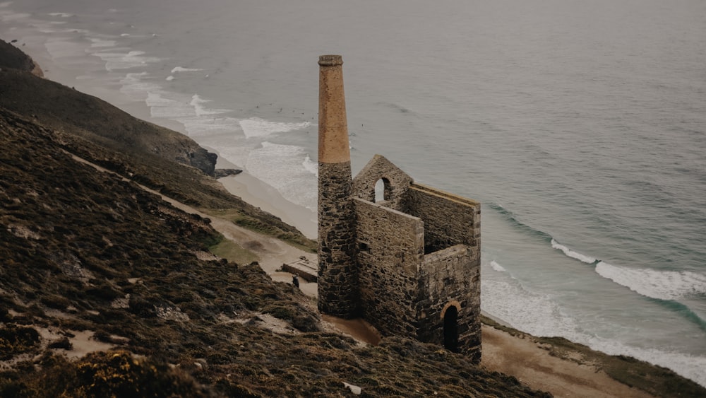 an old building on the side of a cliff overlooking the ocean