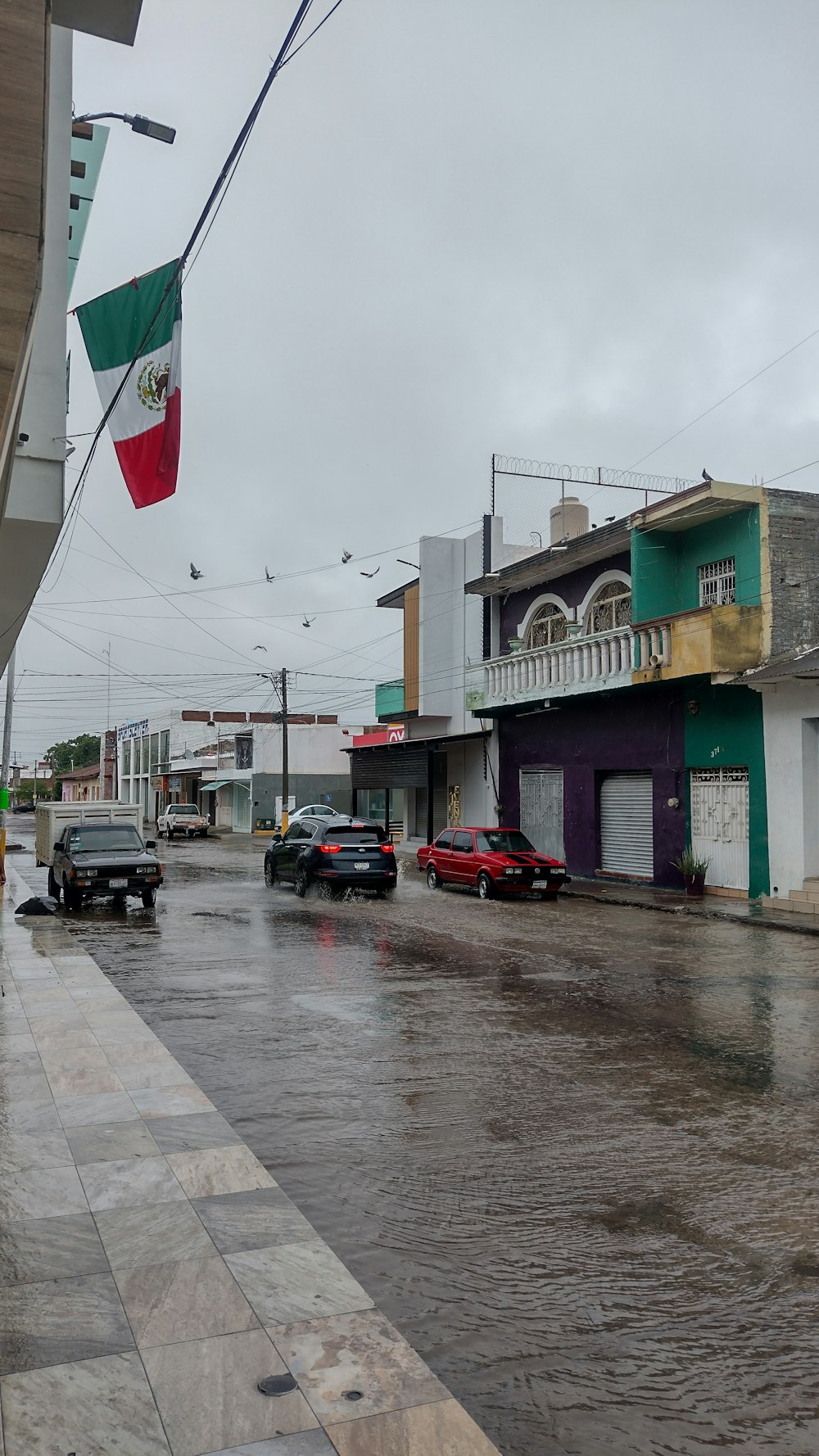 a city street with cars parked on the side of it