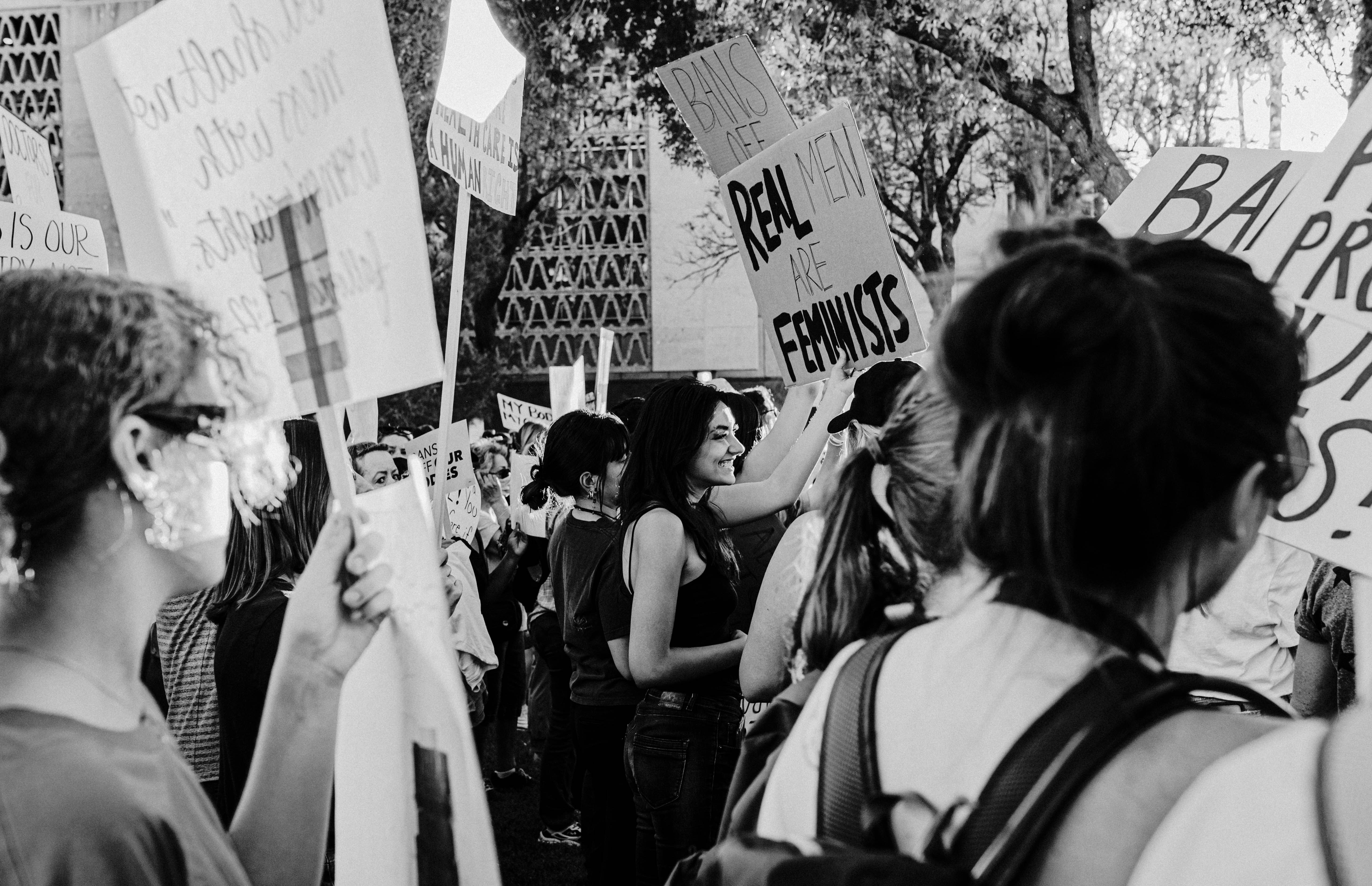 a group of people holding up signs in a protest, 