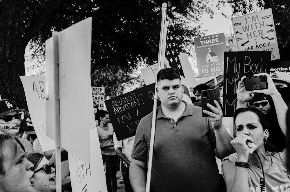 a group of people holding up signs in a protest