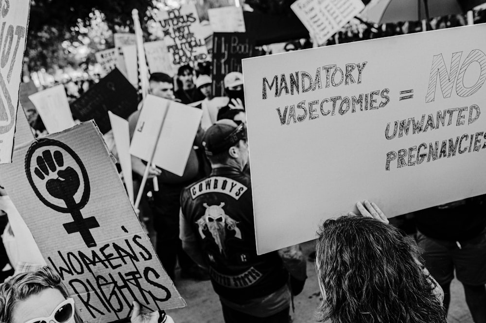 a group of people holding signs and protesting