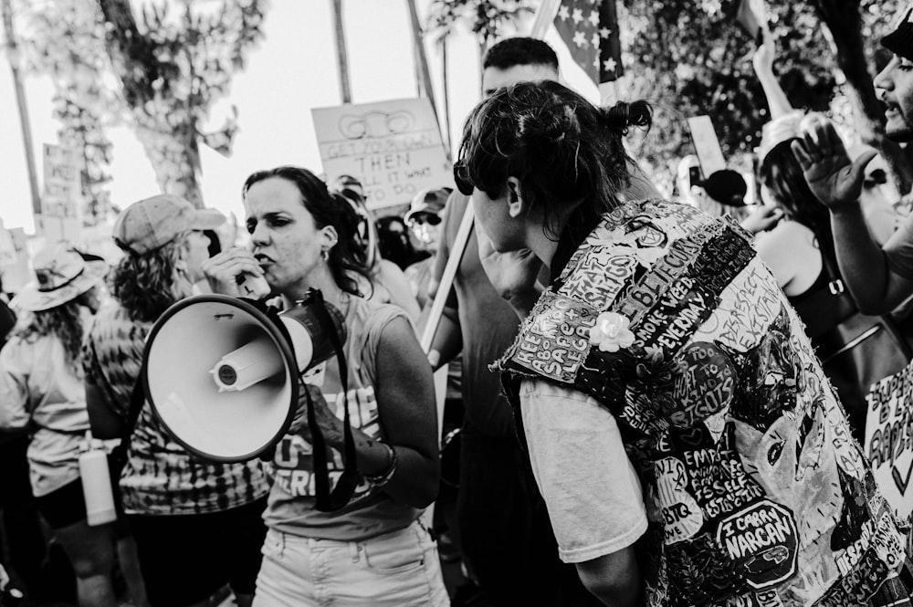 a group of people holding up signs and megaphones