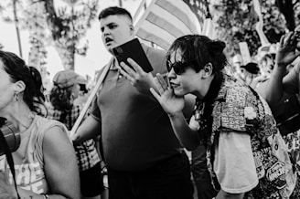 Dramatic snapshot of a political rally showing passionate faces in the crowd.