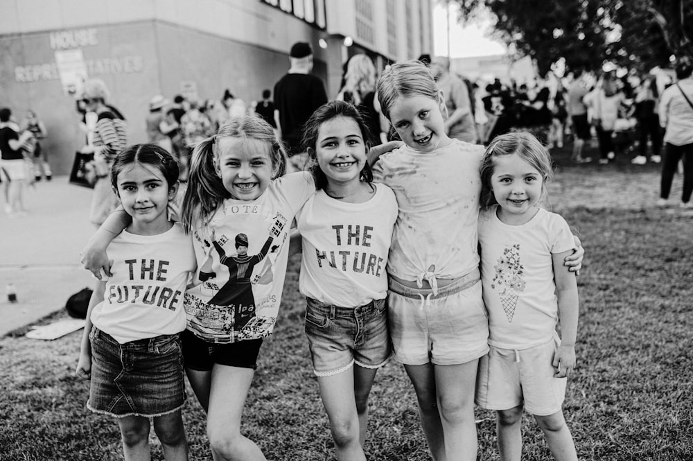 a group of young girls standing next to each other