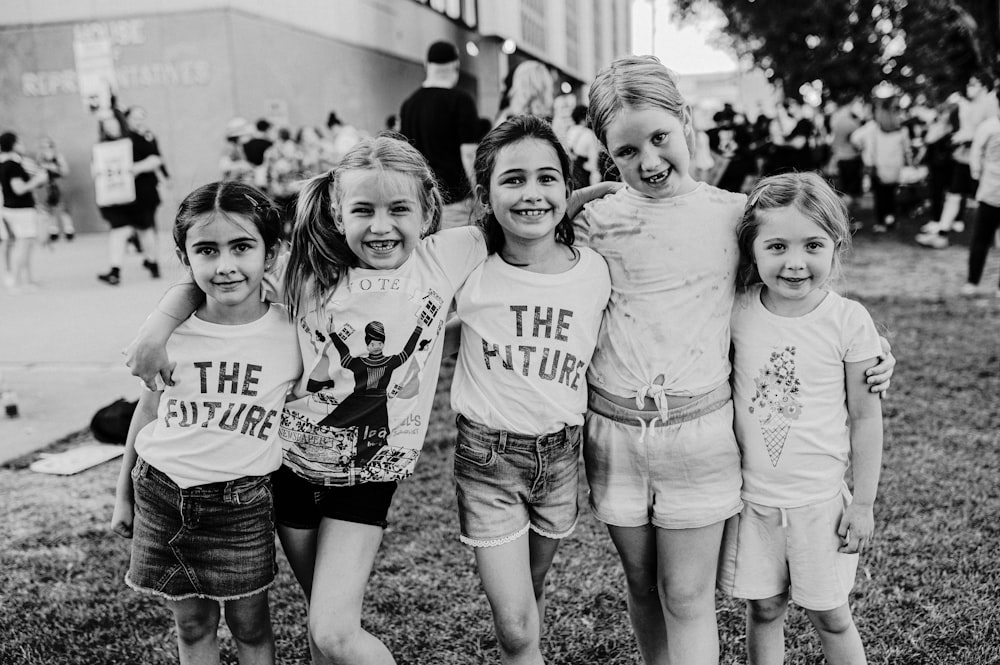 a group of young girls standing next to each other