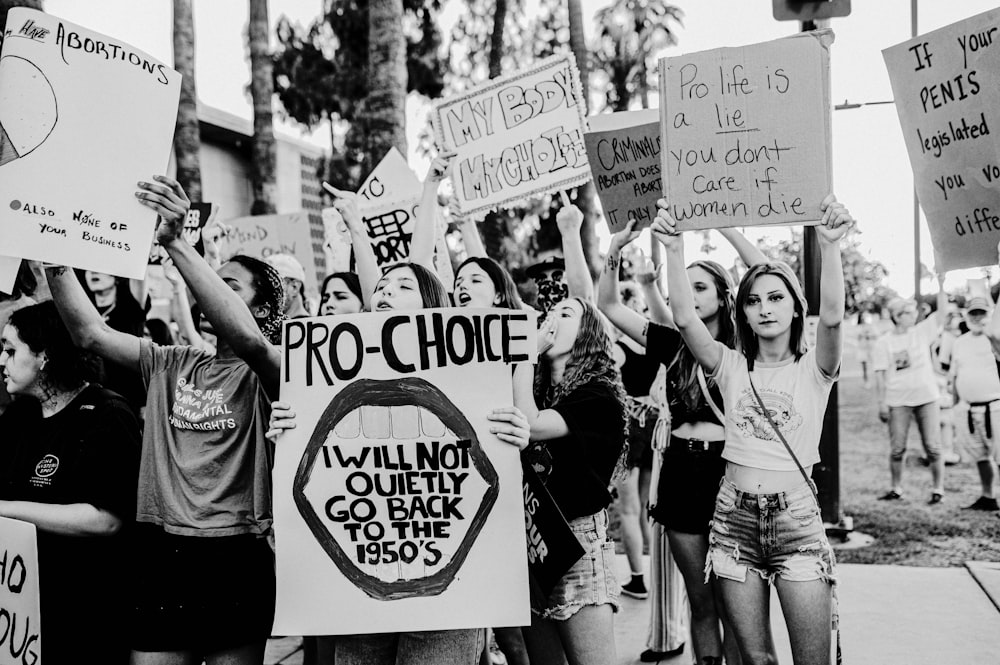 a group of people holding signs and protesting