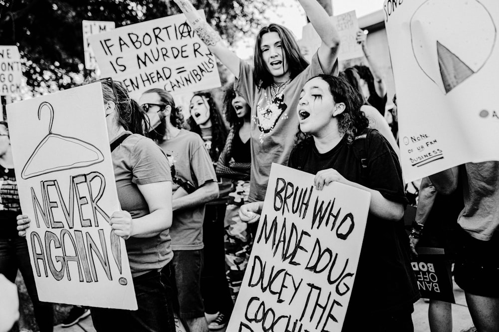 a group of people holding up signs in the air