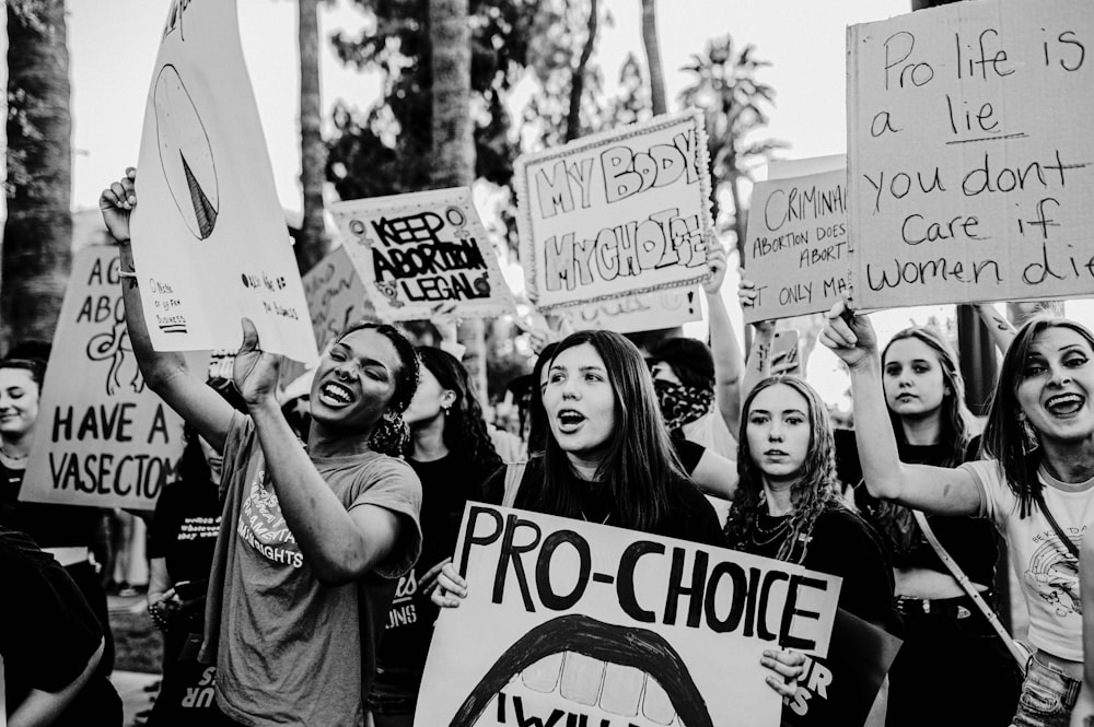 a group of people holding up signs in the air